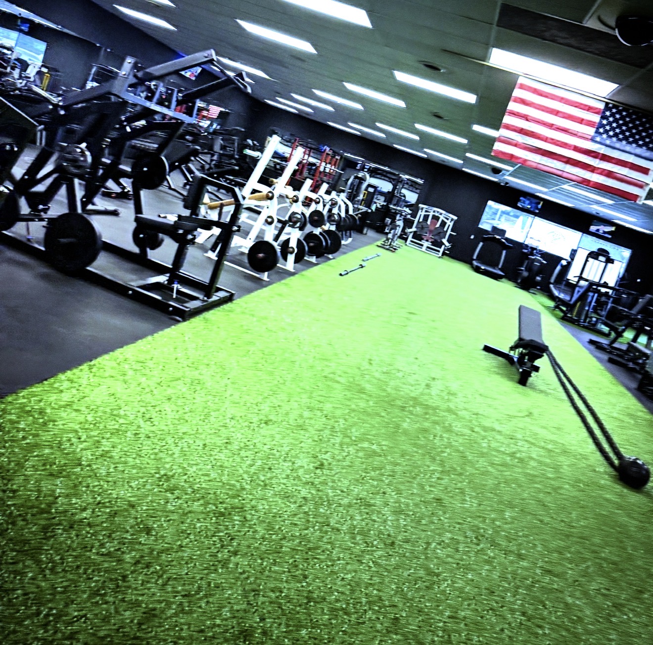 Midwest Iron Addicts Colona training floor with green indoor turf, free weights and strength equipment